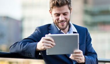 Businessman working on his tablet outside