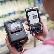 worker in a supermarket using Brother RJ printer