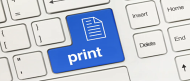 A close up of a standard QWERTY keyboard with the enter/print key in blue with a document icon and the word print written on it